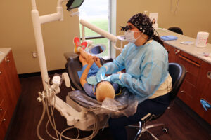 dental hygiene student with young patient